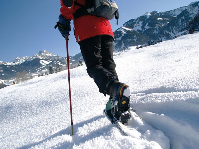 Snow-shoe hiking in the snowy tyrolean Alps at Tannheim